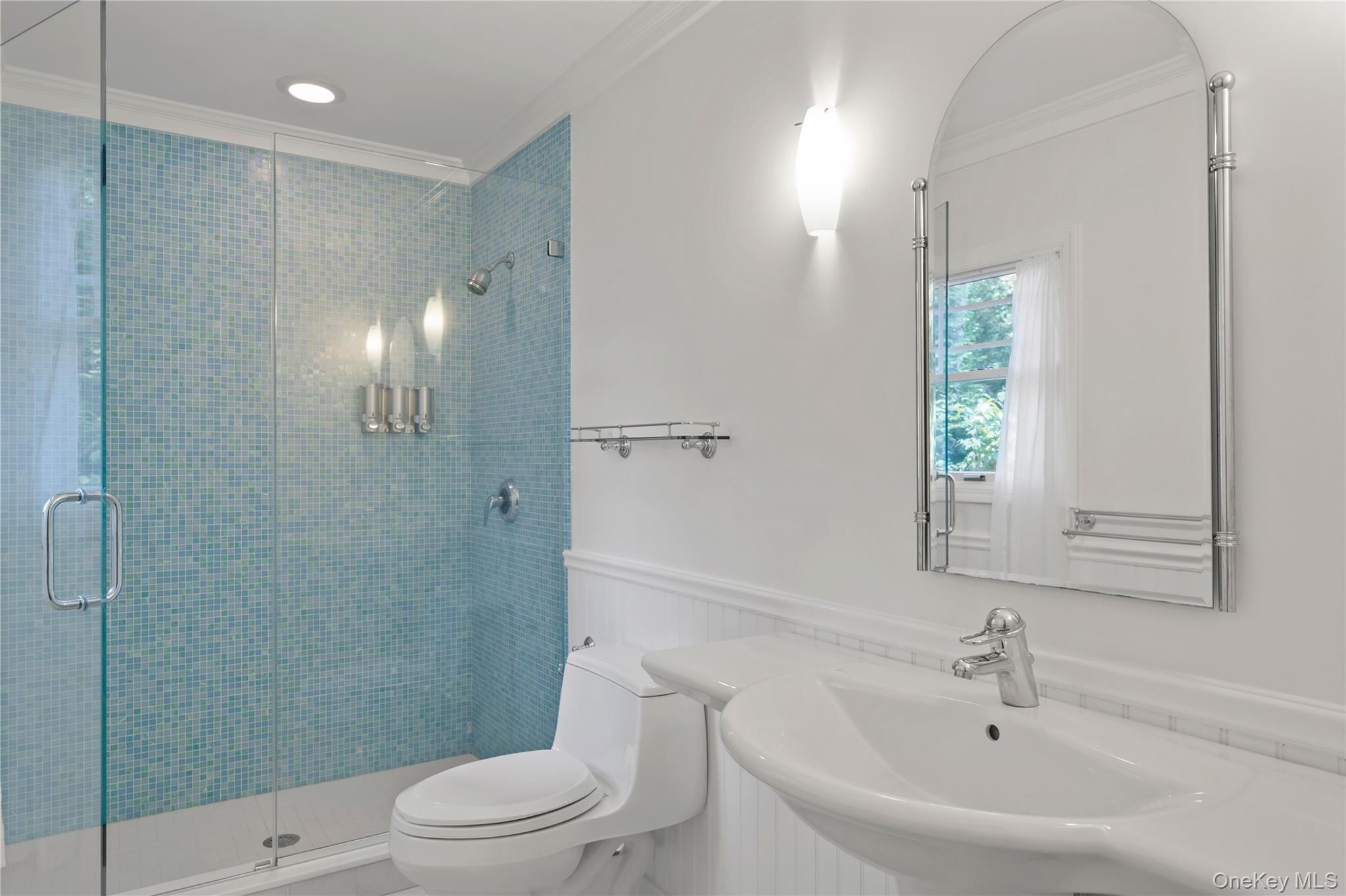 4745 North Bayview Road Southold, NY 11971 - Photo 10 of 31 Bathroom featuring crown molding, wainscoting, and a stall shower