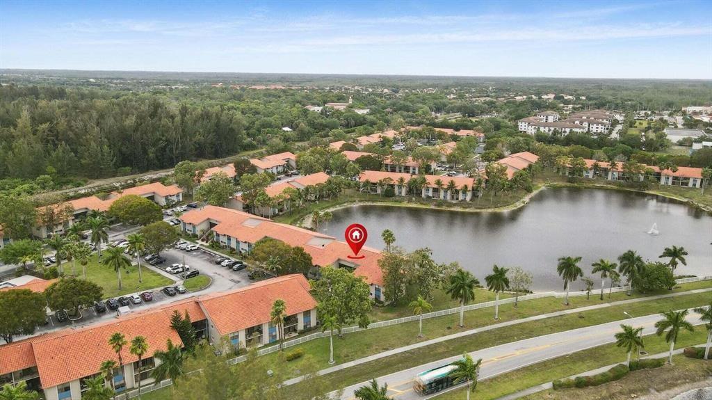 1520 Windorah Way, Unit E West Palm Beach, FL 33411 - Photo 1 of 12 an aerial view of lake residential house with outdoor space