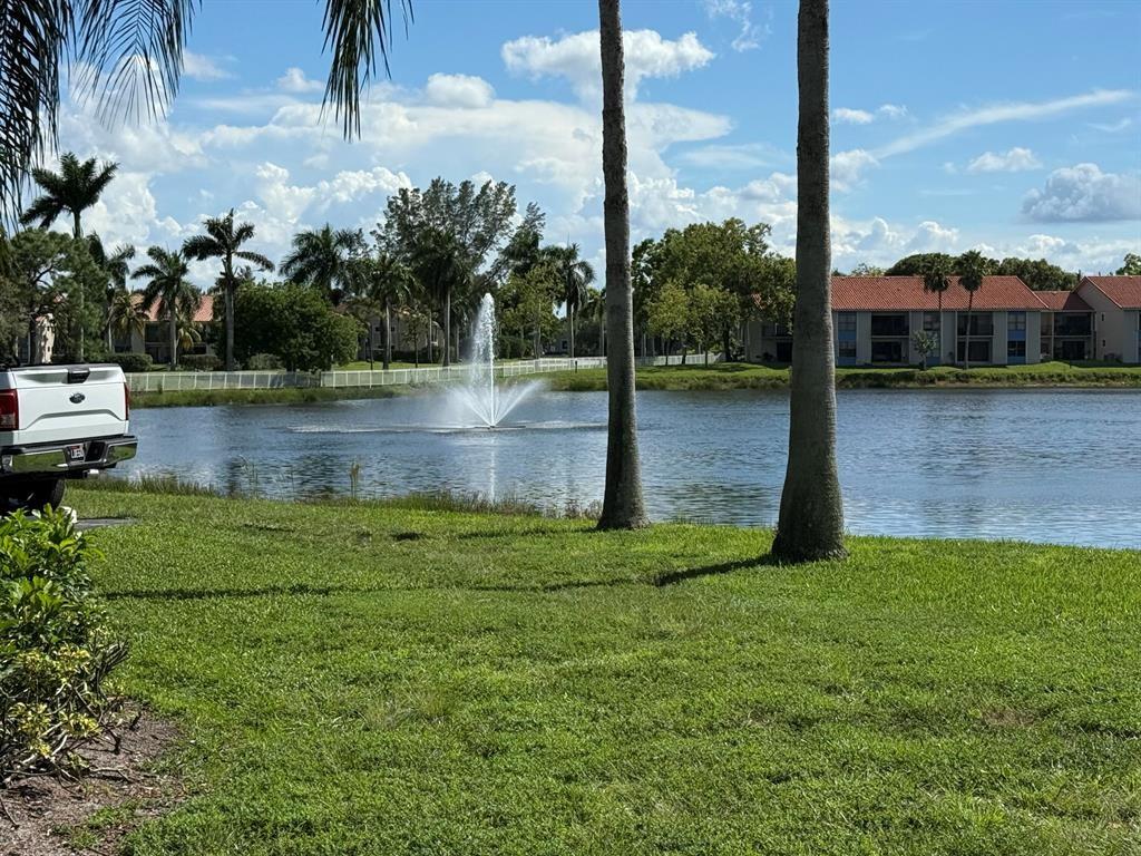 1520 Windorah Way, Unit E West Palm Beach, FL 33411 - Photo 12 of 12 a view of a lake with a yard