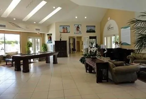 a living room with furniture a large window and a dining table