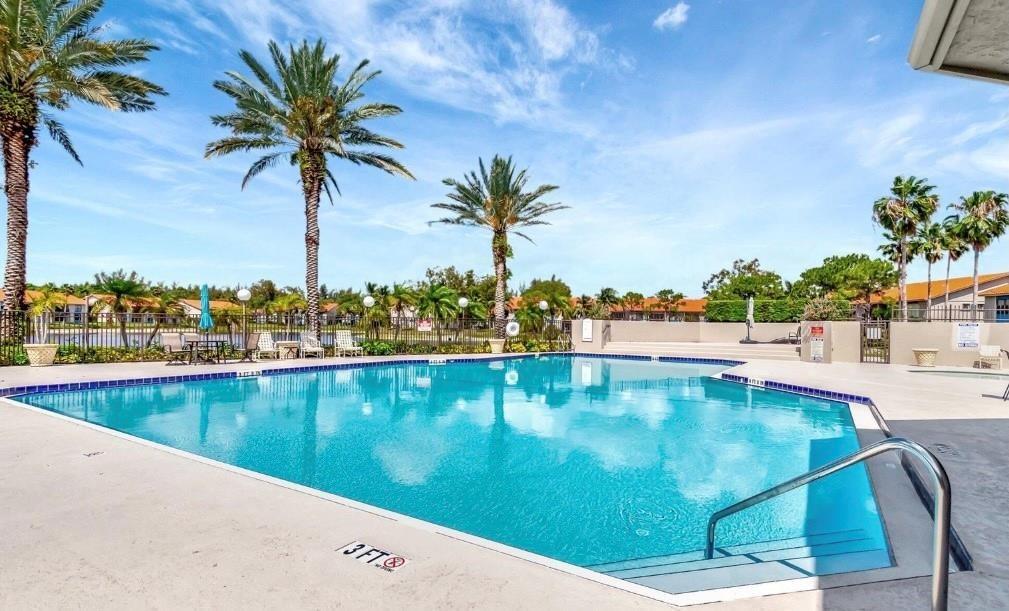 1520 Windorah Way, Unit E West Palm Beach, FL 33411 - Photo 8 of 12 a view of a swimming pool and a chair