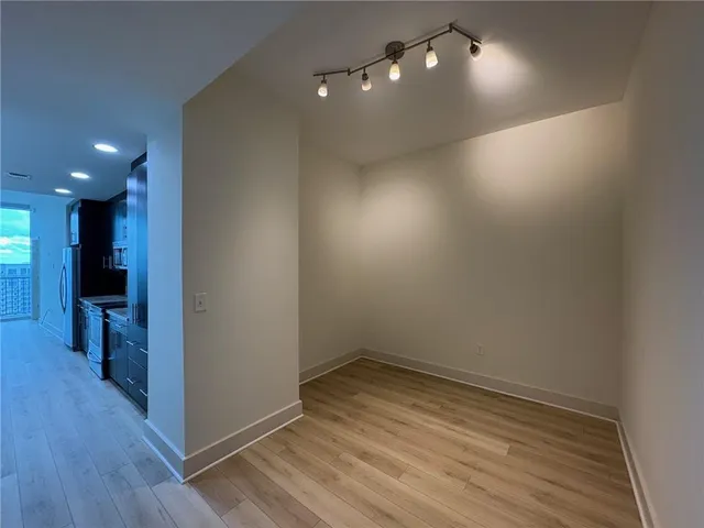 a view of empty room with wooden floor