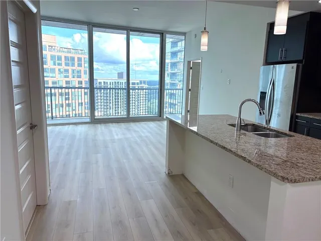 a kitchen with a sink and large window