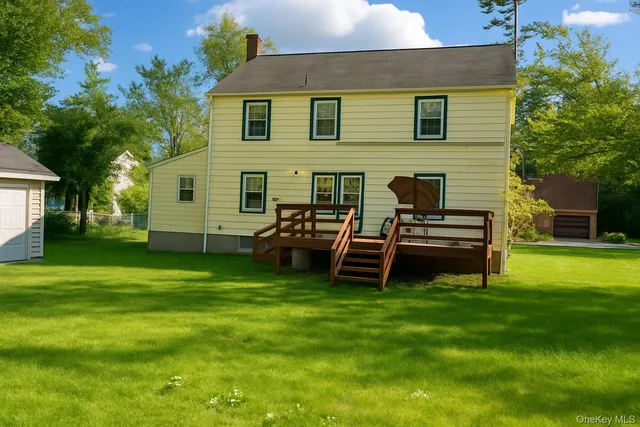 a view of a house with a backyard