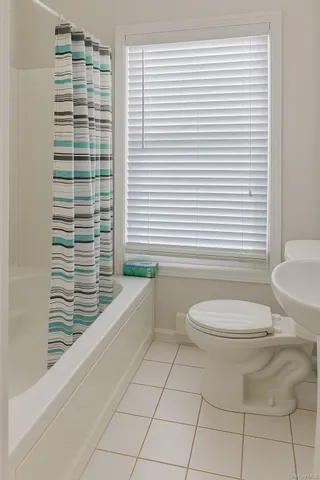 a bathroom with a toilet a sink and bathtub