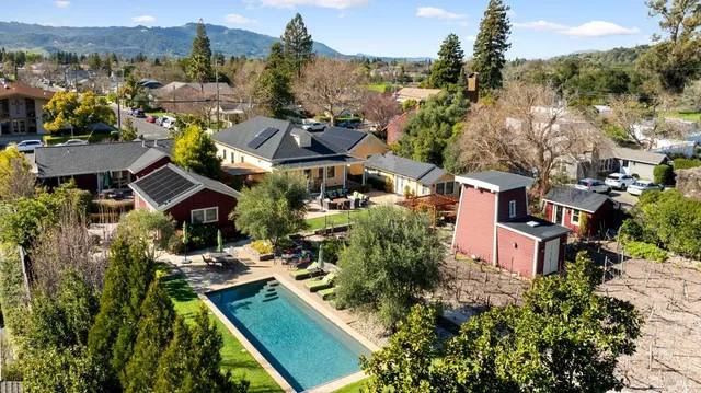 an aerial view of multiple houses with a yard