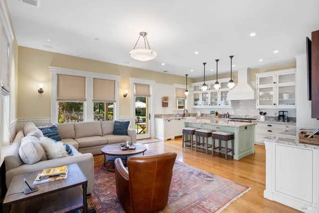a living room with lots of furniture and kitchen view
