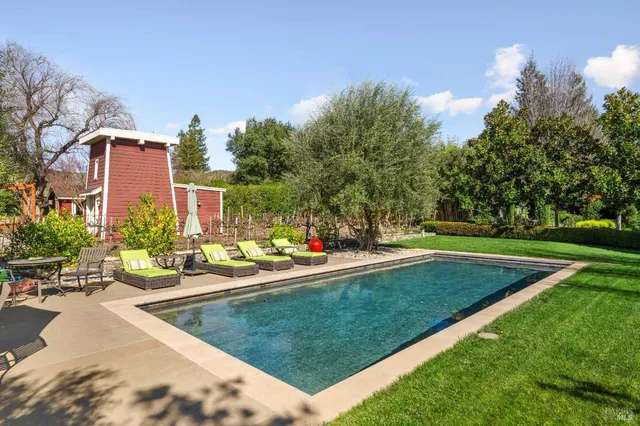 a view of a swimming pool and lounge chairs