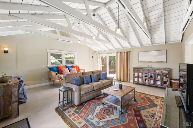 a kitchen with granite countertop white cabinets and sink