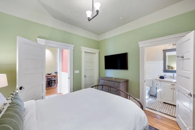 a bedroom with a bed and a flat screen tv