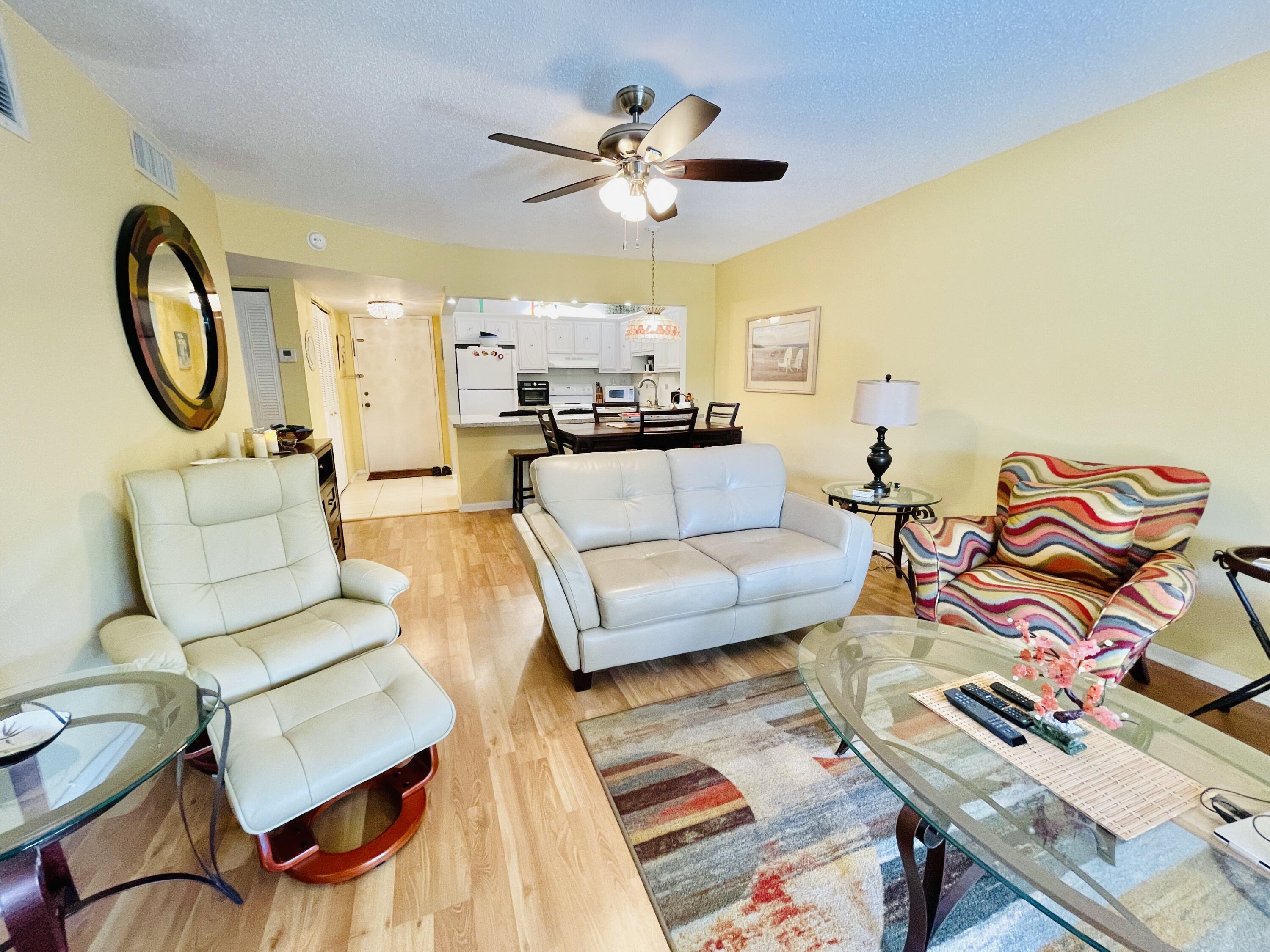 257 South Cypress Road, Unit 442 Pompano Beach, FL 33060 - Photo 11 of 37 a living room with furniture and a chandelier