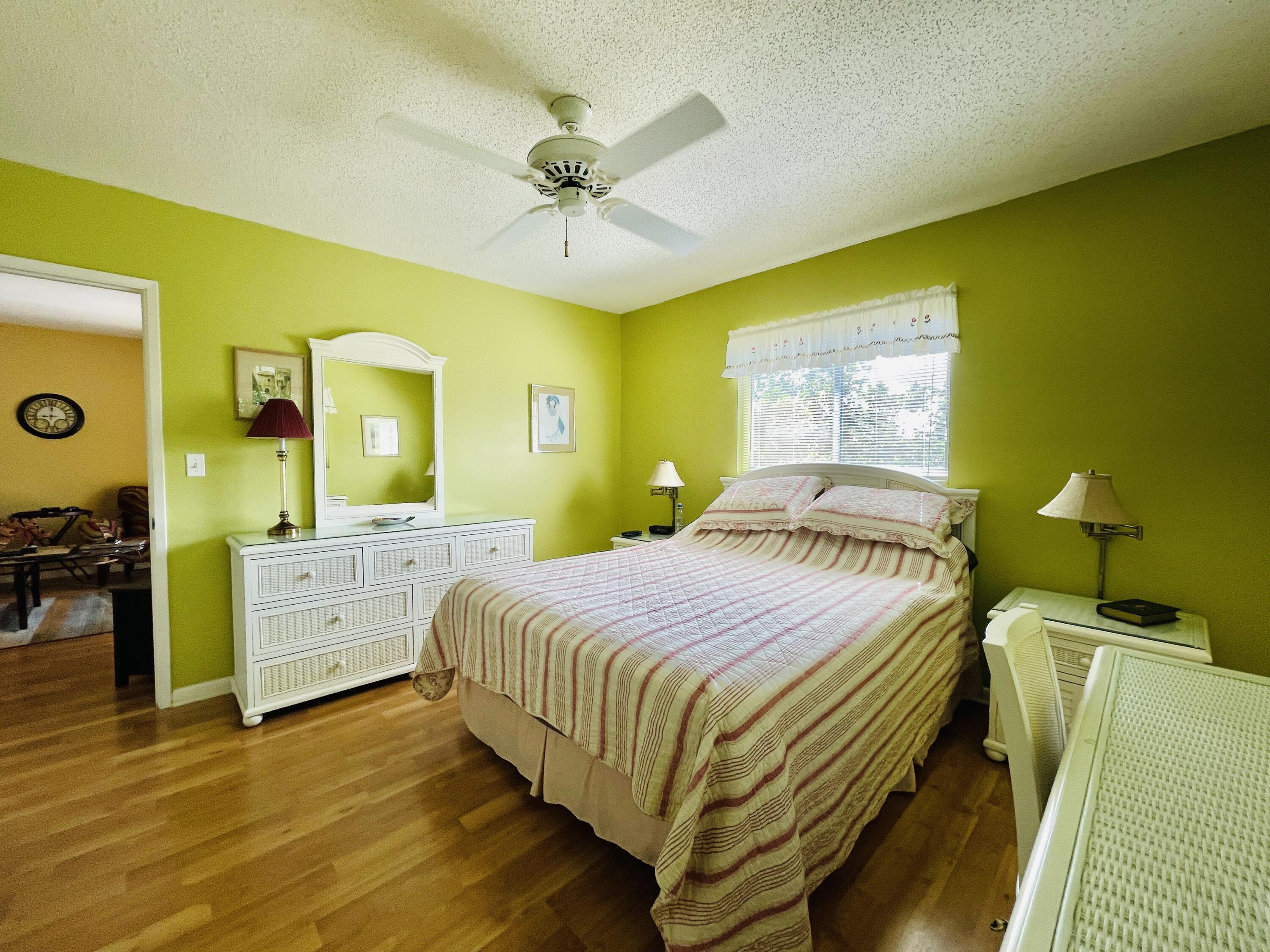 257 South Cypress Road, Unit 442 Pompano Beach, FL 33060 - Photo 12 of 37 a bedroom with a bed and a chandelier