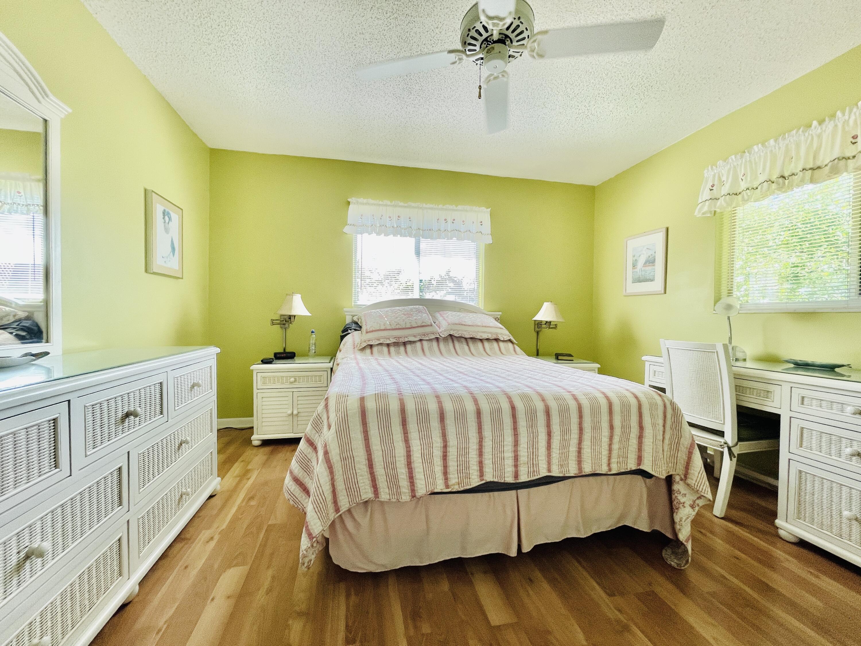257 South Cypress Road, Unit 442 Pompano Beach, FL 33060 - Photo 13 of 37 a bedroom with a bed and wooden floor