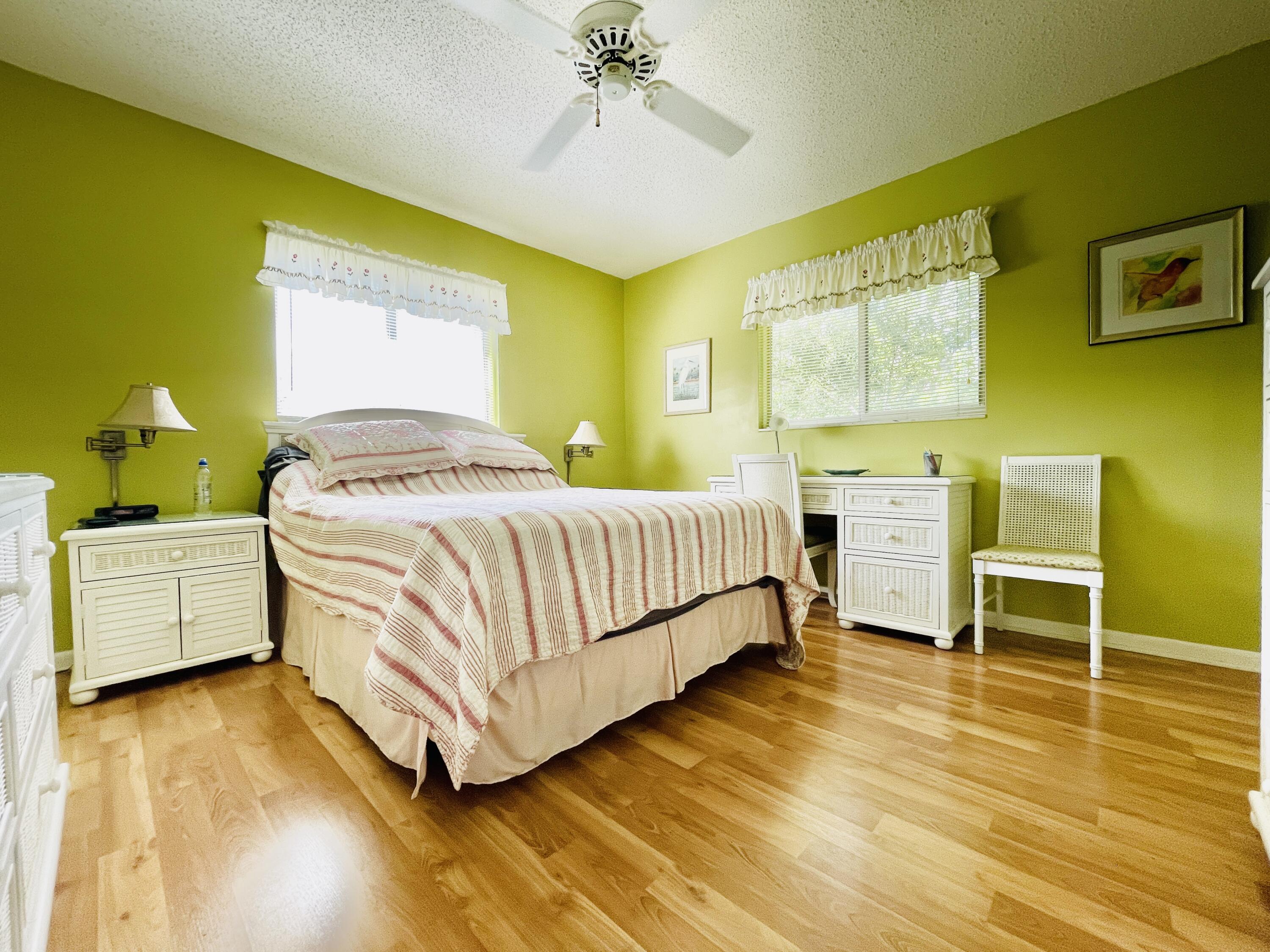 257 South Cypress Road, Unit 442 Pompano Beach, FL 33060 - Photo 14 of 37 a bedroom with a bed and a table in it