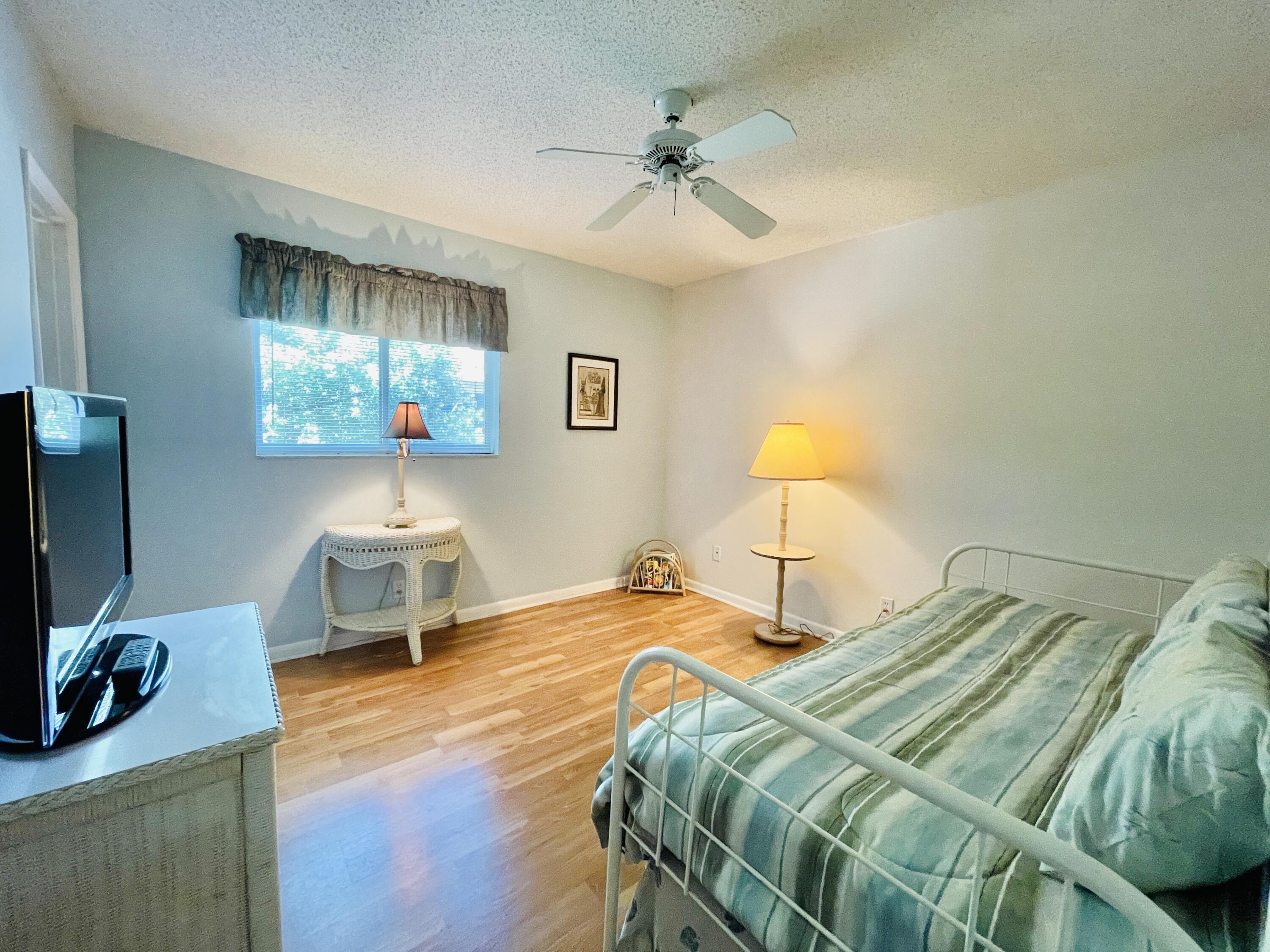 257 South Cypress Road, Unit 442 Pompano Beach, FL 33060 - Photo 17 of 37 a bedroom with a bed and a flat screen tv