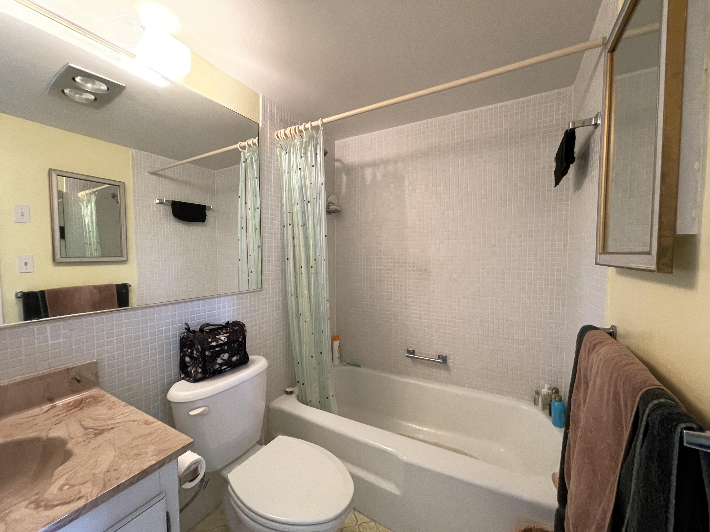 257 South Cypress Road, Unit 442 Pompano Beach, FL 33060 - Photo 19 of 37 a bathroom with a sink a toilet and a bathtub