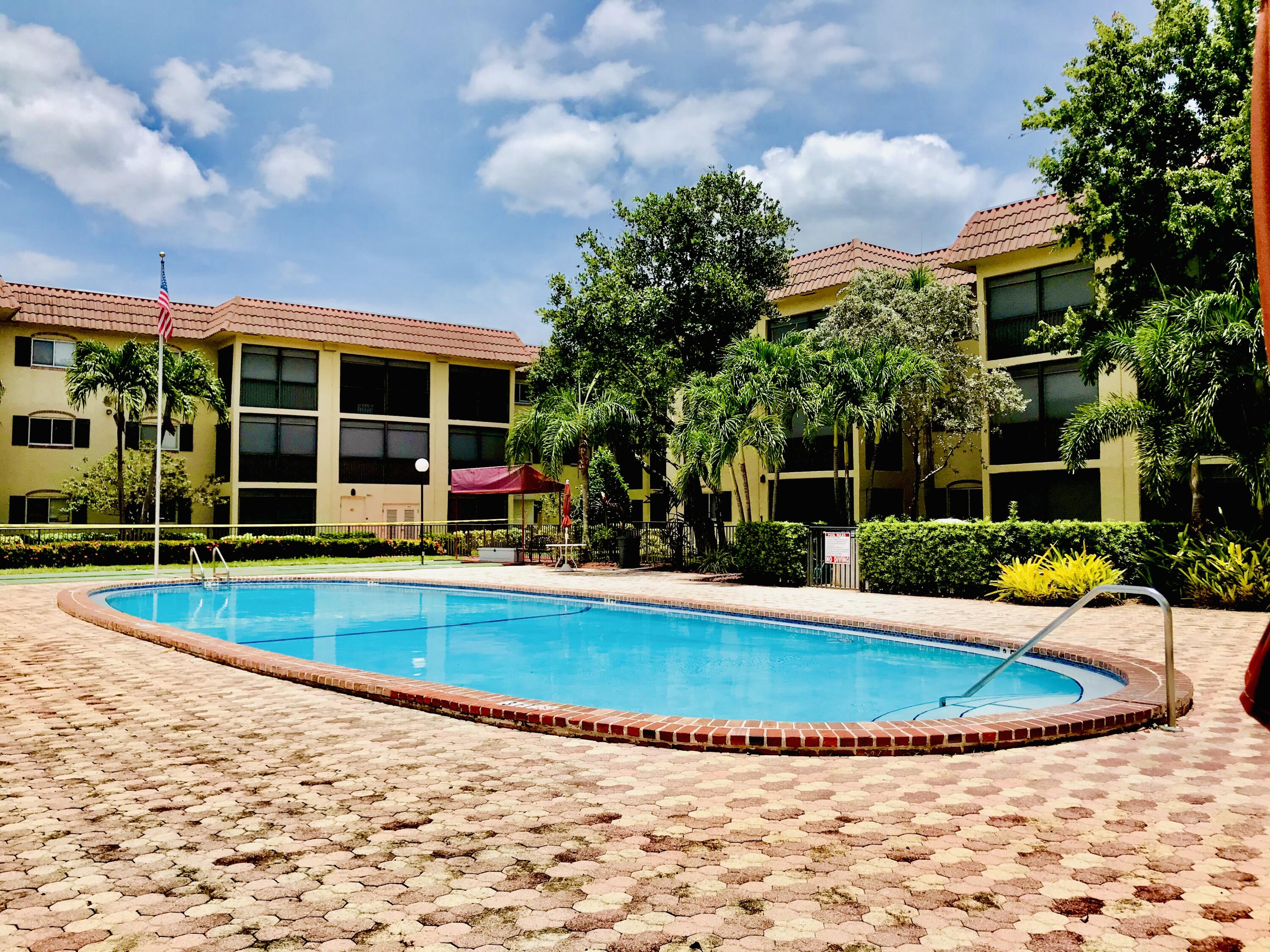 257 South Cypress Road, Unit 442 Pompano Beach, FL 33060 - Photo 21 of 37 a view of a house with swimming pool and porch