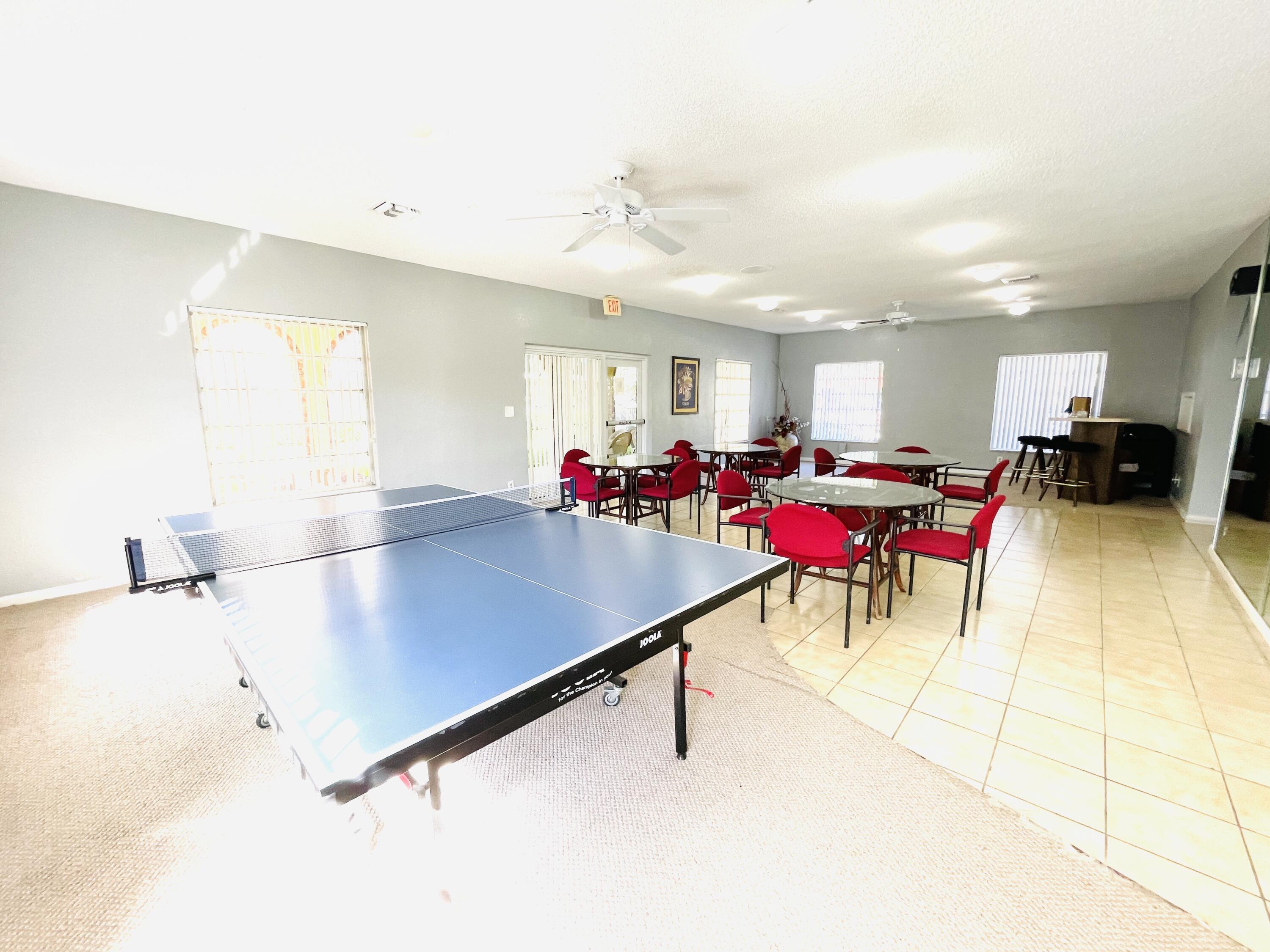 257 South Cypress Road, Unit 442 Pompano Beach, FL 33060 - Photo 30 of 37 a room with table tennis and air hockey table