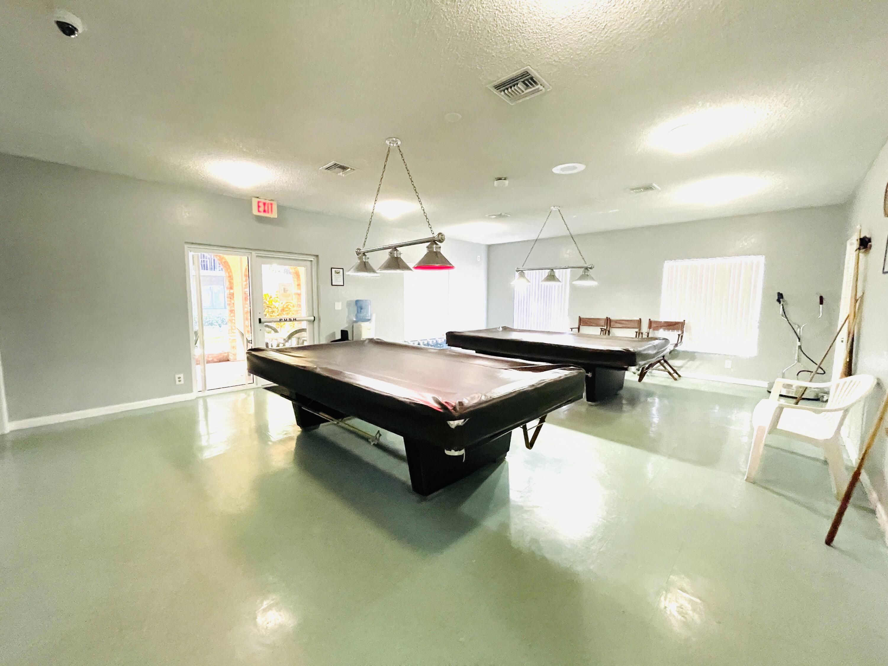 257 South Cypress Road, Unit 442 Pompano Beach, FL 33060 - Photo 31 of 37 a living room with kitchen pool table and chairs