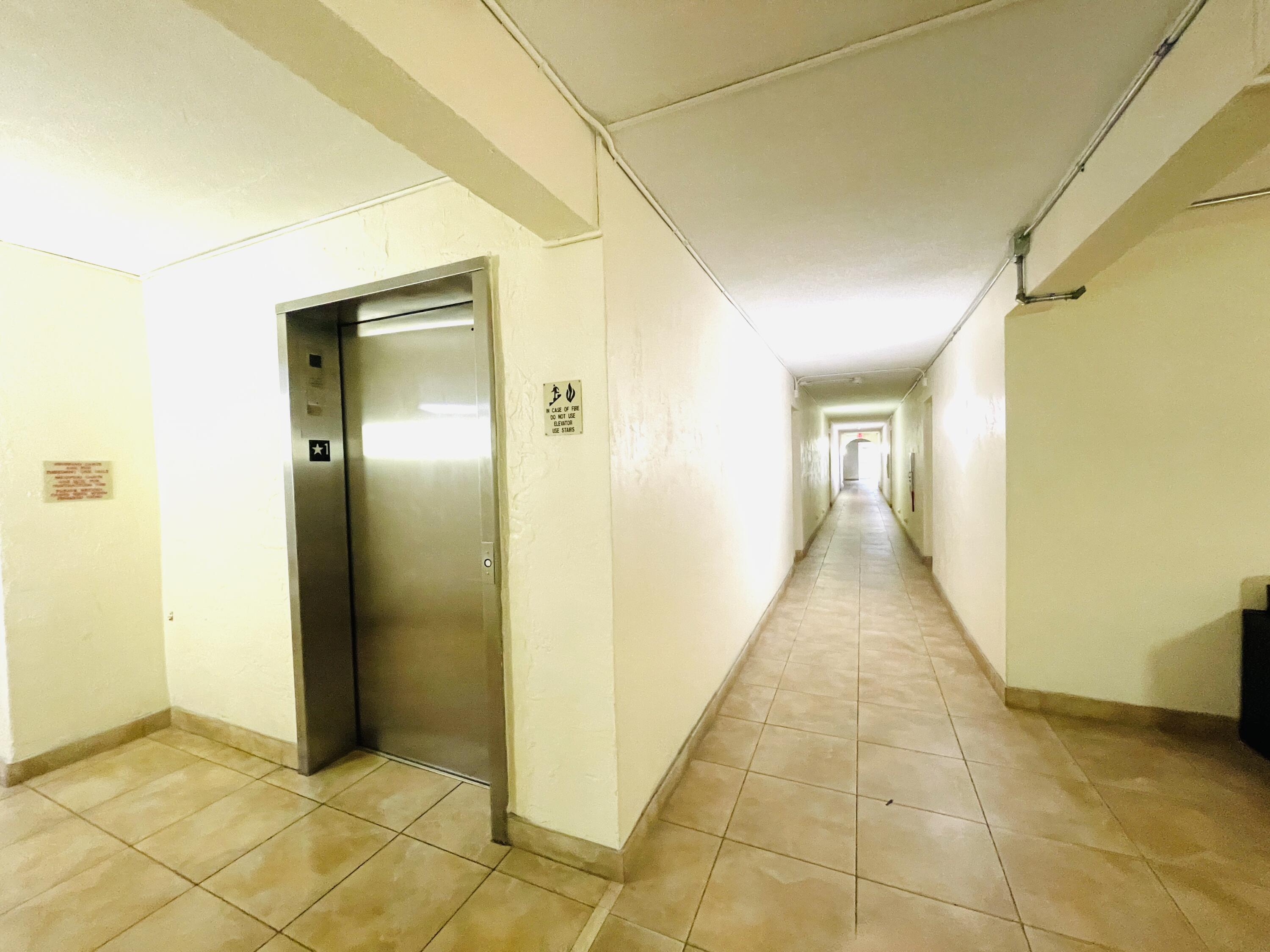 257 South Cypress Road, Unit 442 Pompano Beach, FL 33060 - Photo 35 of 37 a view of a hallway with wooden floor