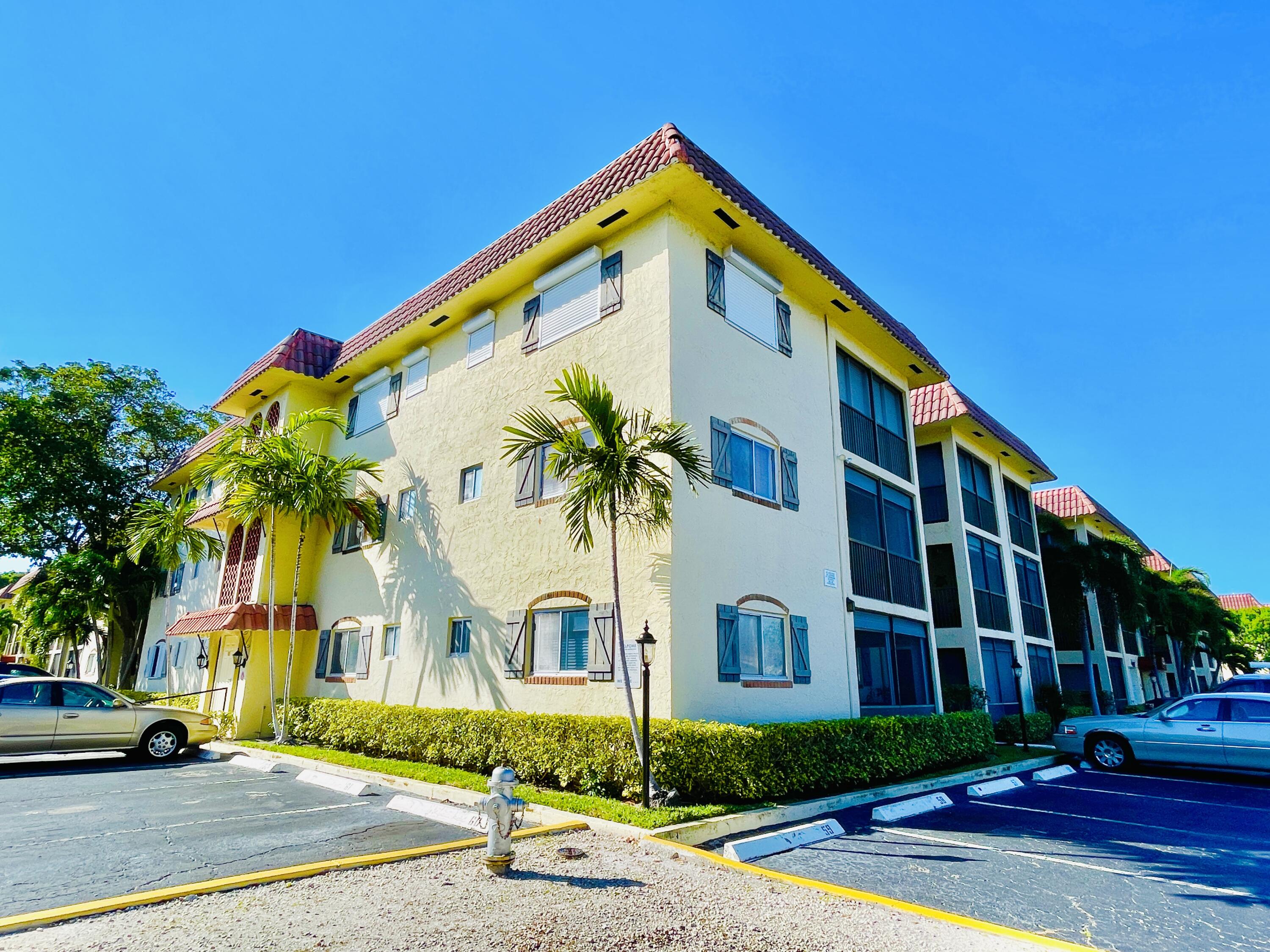 257 South Cypress Road, Unit 442 Pompano Beach, FL 33060 - Photo 37 of 37 a front view of residential houses with street and trees