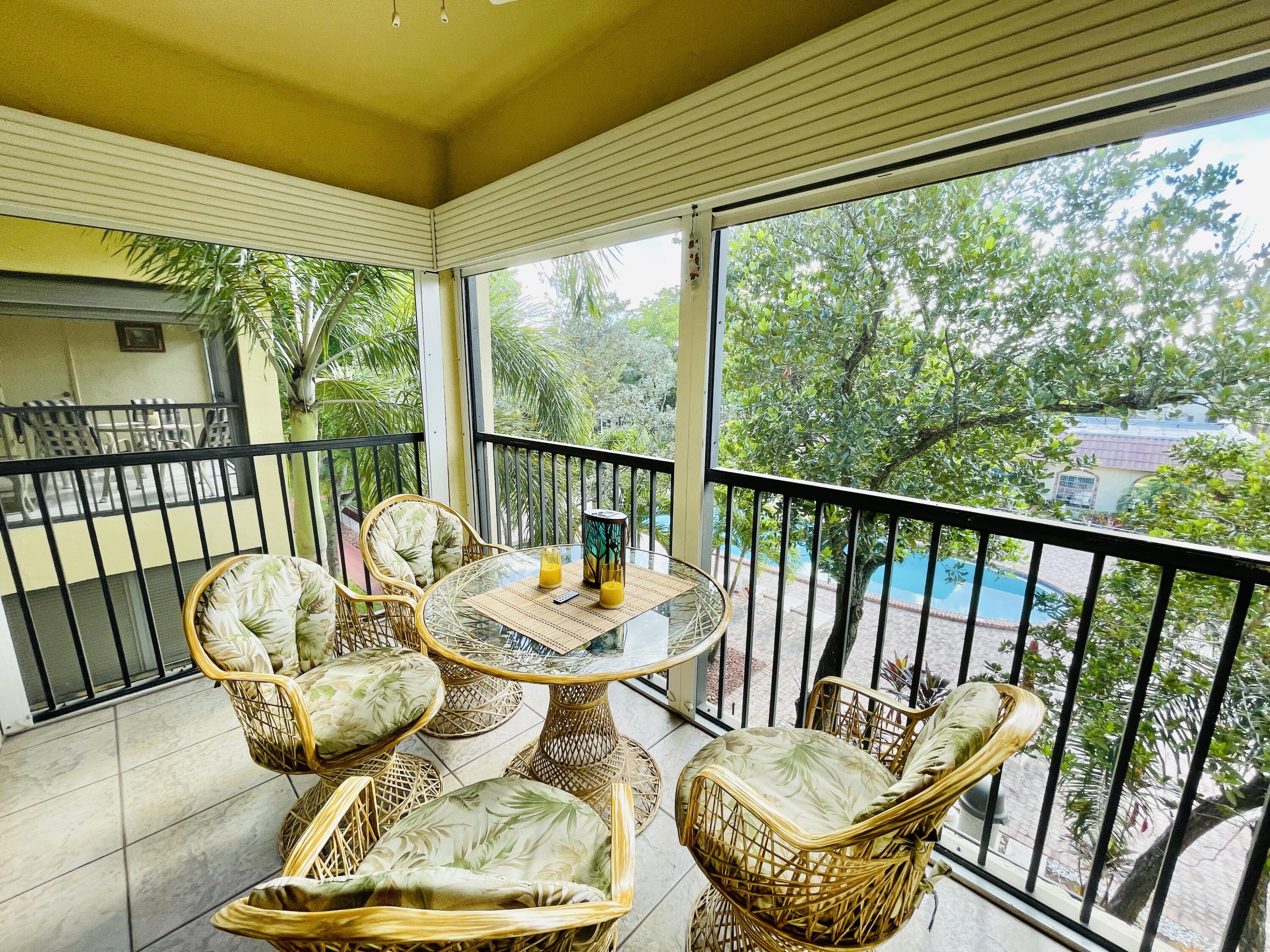 257 South Cypress Road, Unit 442 Pompano Beach, FL 33060 - Photo 4 of 37 a view of a balcony with chair and a potted plant
