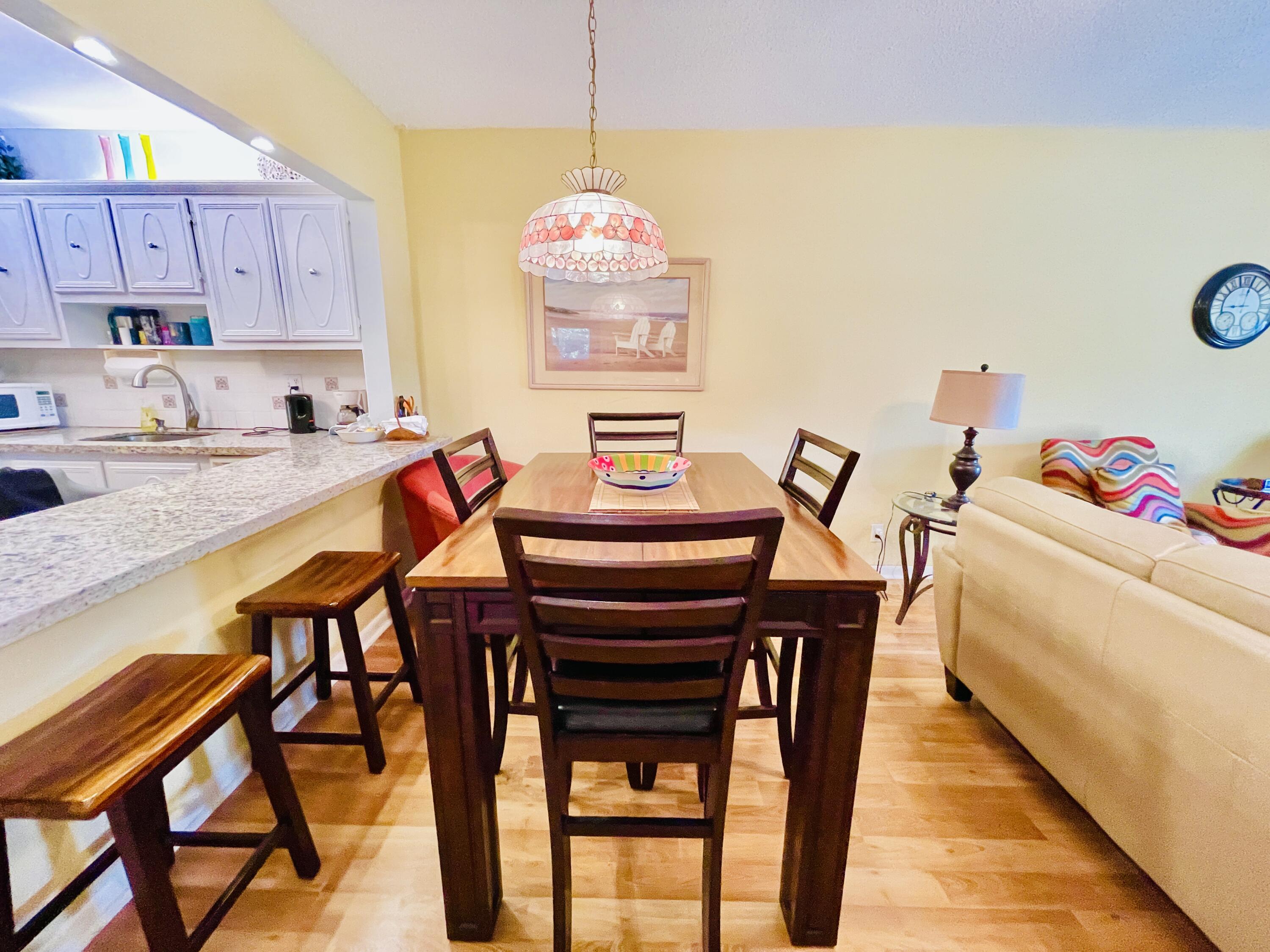 257 South Cypress Road, Unit 442 Pompano Beach, FL 33060 - Photo 8 of 37 a view of a dining room with furniture and wooden floor