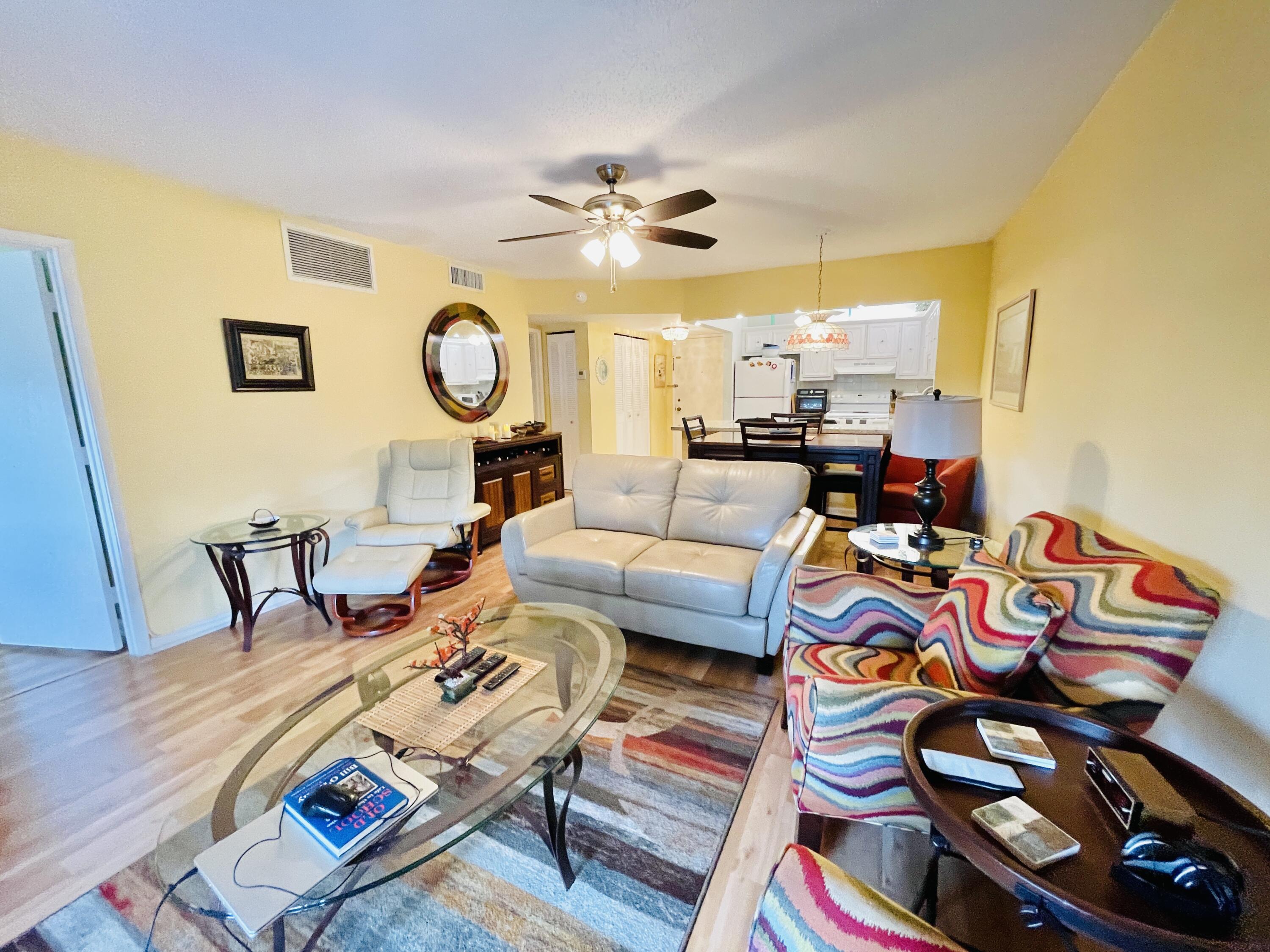 257 South Cypress Road, Unit 442 Pompano Beach, FL 33060 - Photo 10 of 37 a living room with furniture and a clock