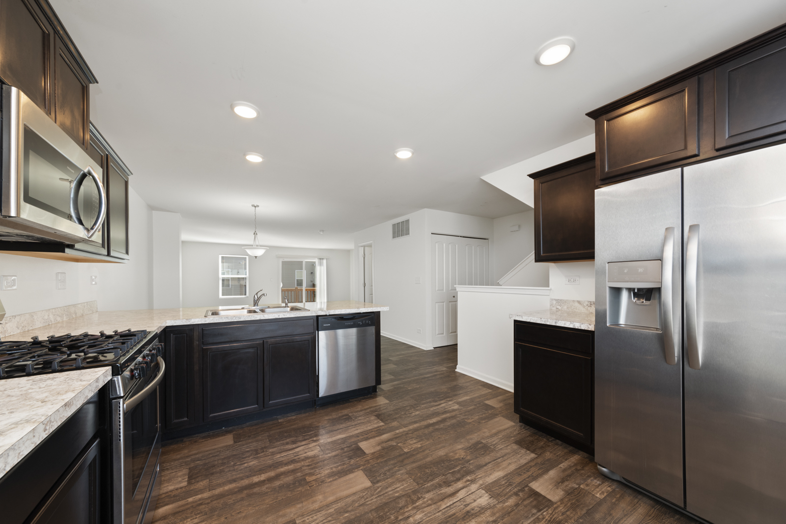 2307 Upland Road Pingree Grove, IL 60140 - Photo 4 of 30 a kitchen with stainless steel appliances granite countertop a sink stove and refrigerator