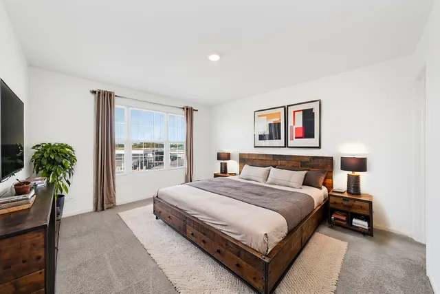a bedroom with a bed and a potted plant