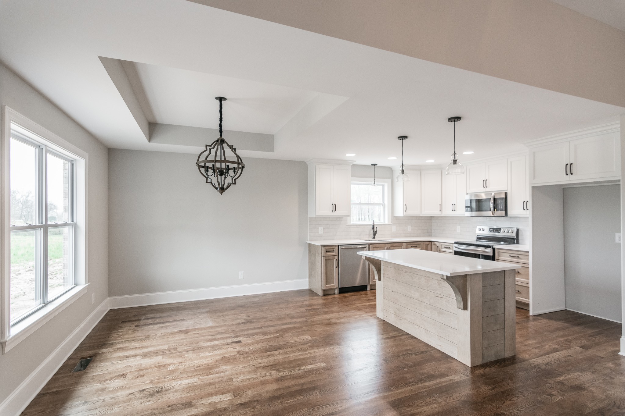 1227 Friendship Road Cross Plains, TN 37049 - Photo 12 of 28 a open kitchen with stainless steel appliances granite countertop a stove top oven a sink dishwasher and a refrigerator with wooden floor