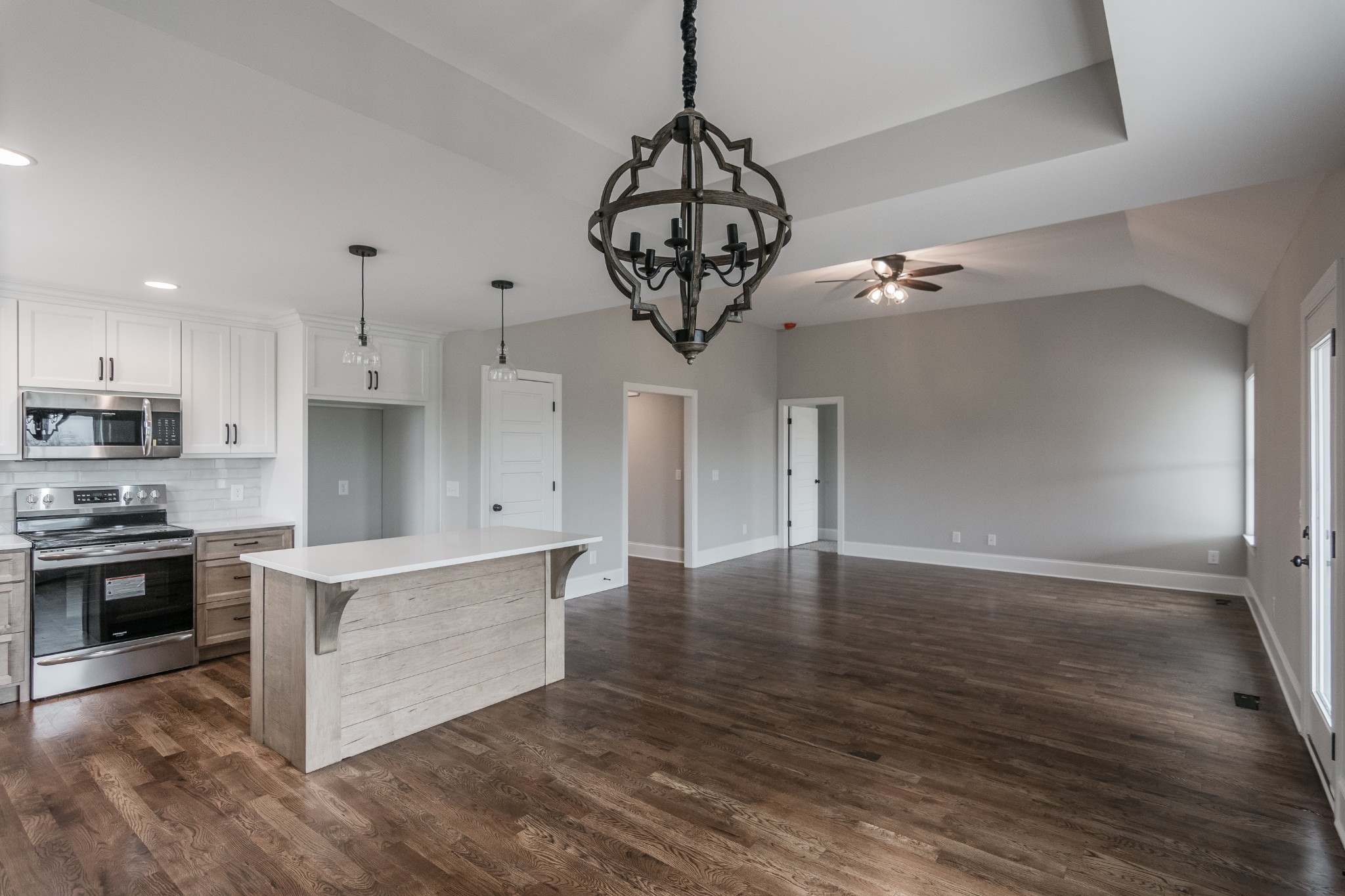 1227 Friendship Road Cross Plains, TN 37049 - Photo 13 of 28 a view of a kitchen with stainless steel appliances granite countertop a stove top oven a refrigerator a sink and a dining table with wooden floor