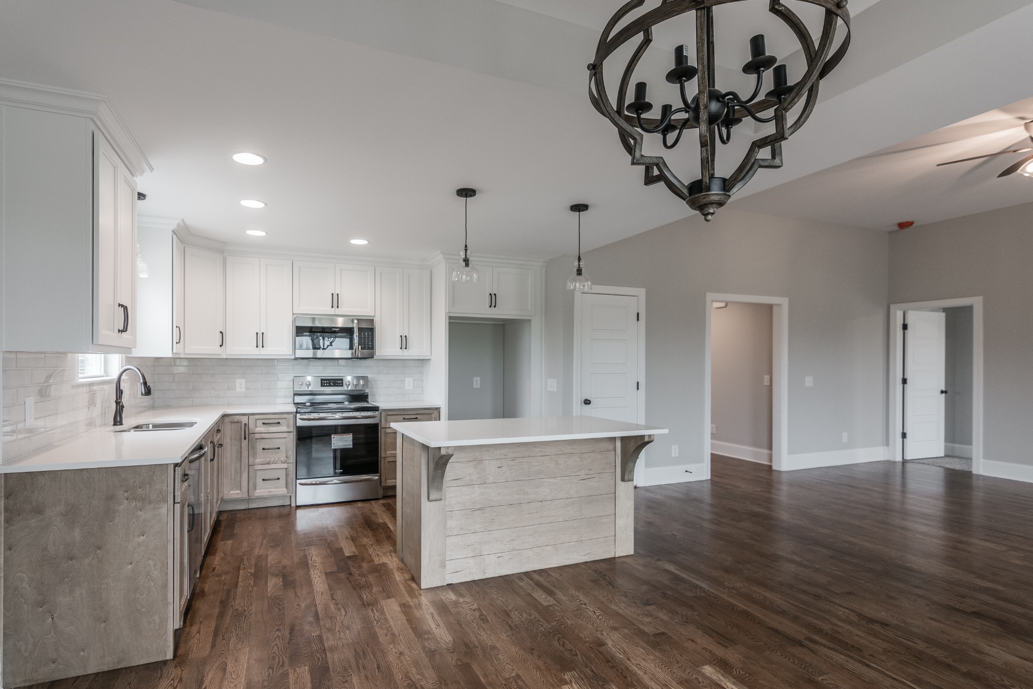 1227 Friendship Road Cross Plains, TN 37049 - Photo 15 of 28 a kitchen with a chandelier stainless steel appliances cabinets and a wooden floor