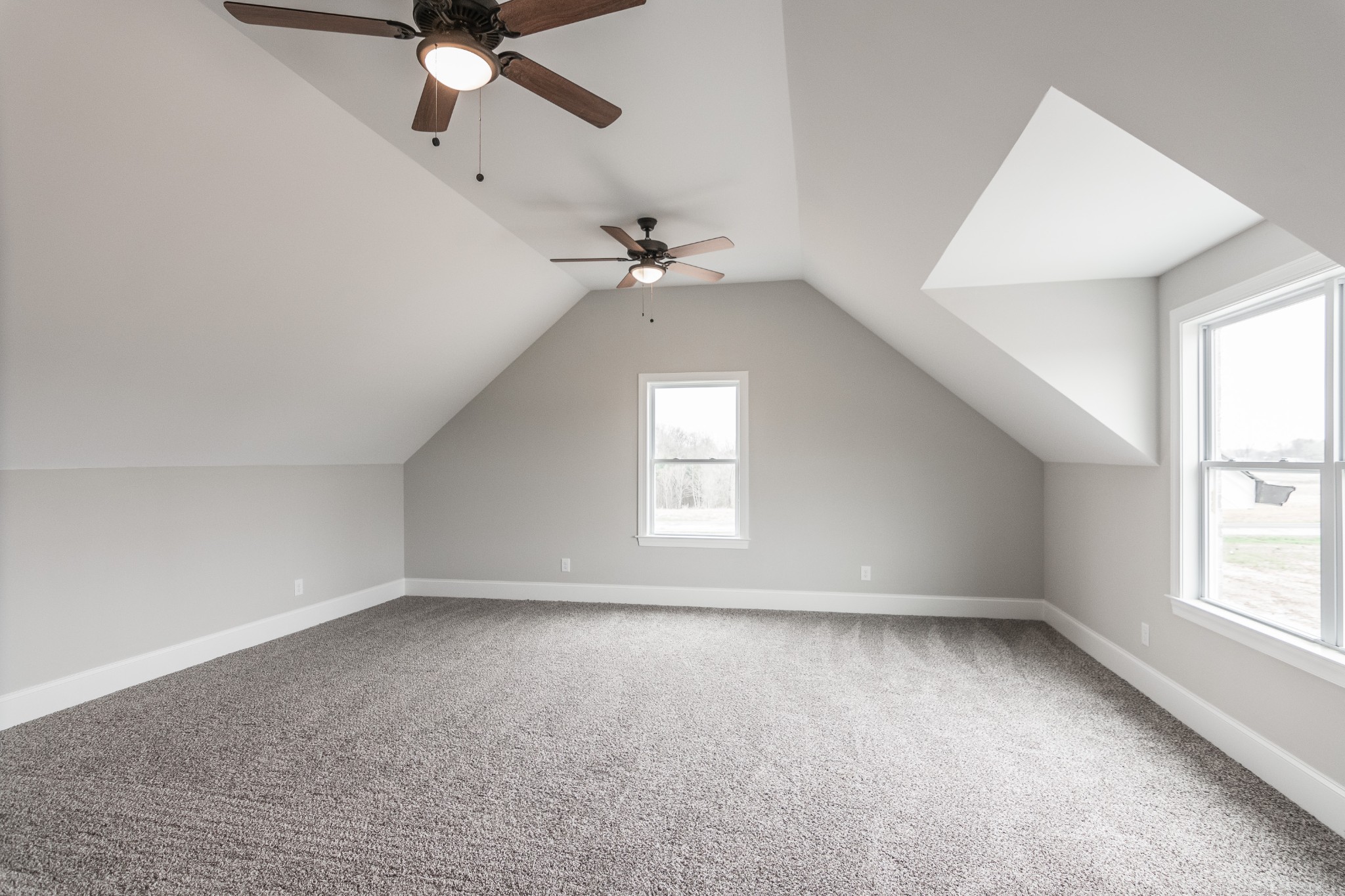 1227 Friendship Road Cross Plains, TN 37049 - Photo 28 of 28 an empty room with a ceiling fan and windows