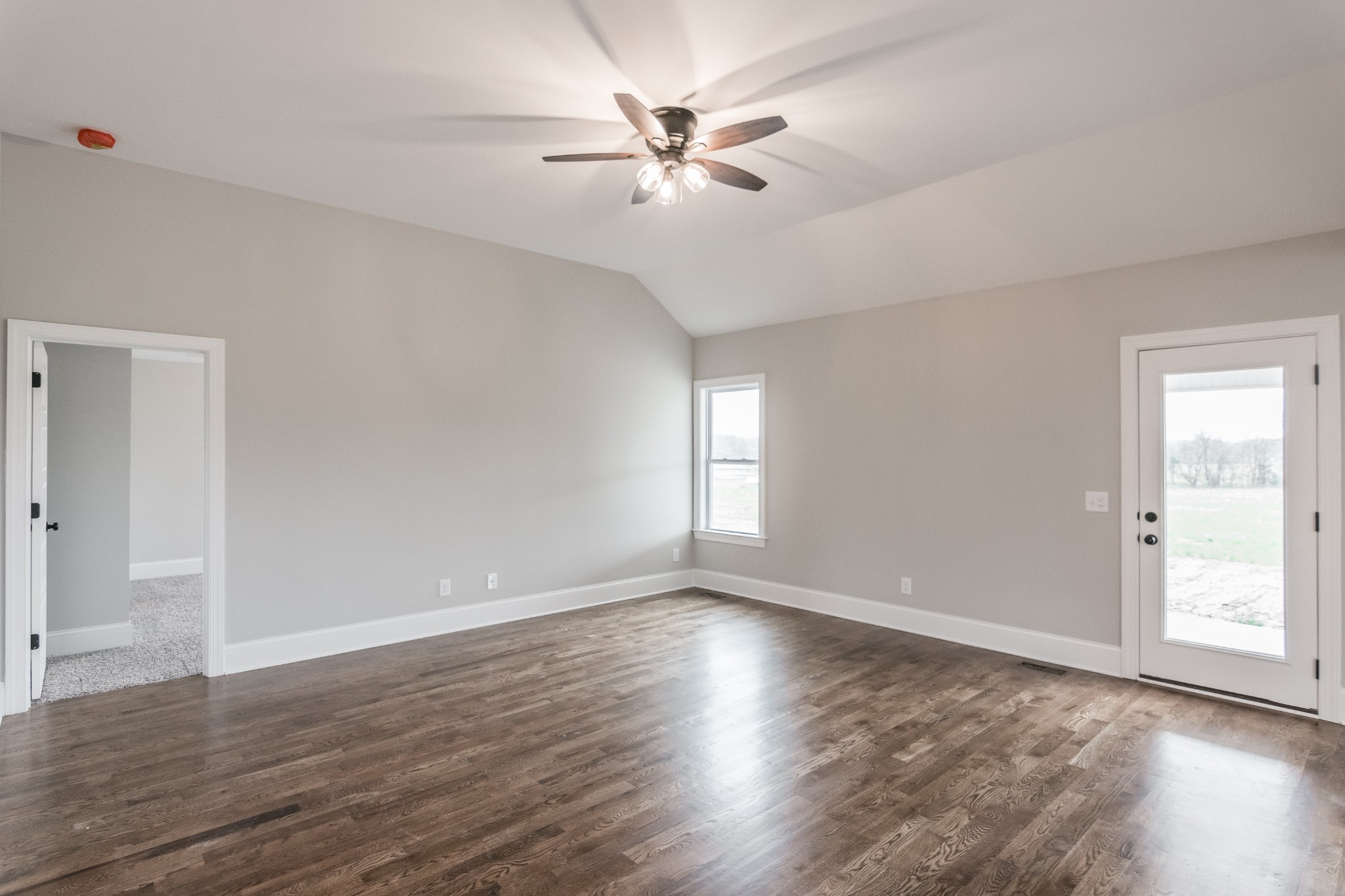 1227 Friendship Road Cross Plains, TN 37049 - Photo 10 of 28 an empty room with wooden floor and ceiling fan