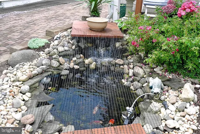 a view of a patio with table and chairs and potted plants