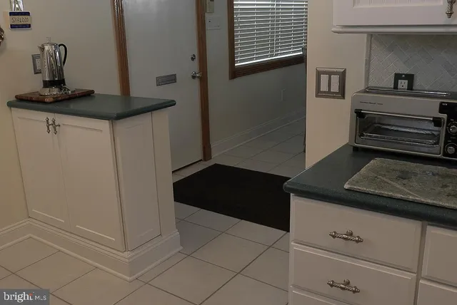 a bathroom with a window and a toilet