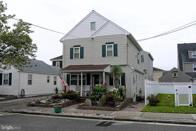 a potted plant sitting in front of a house with a yard