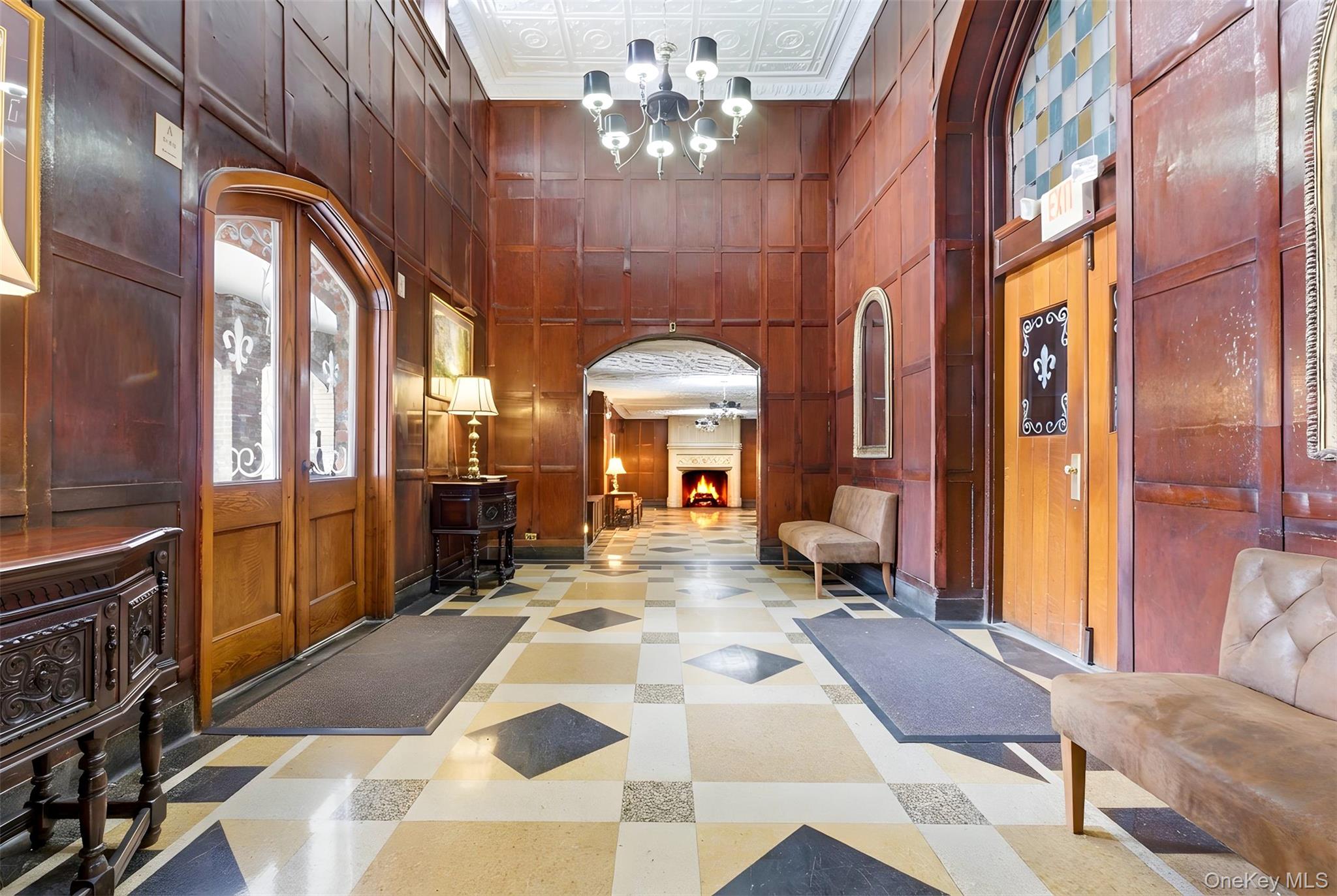 270 Bronxville Road, Unit B22 Bronxville, NY 10708 - Photo 4 of 23 Building lobby with a high ceiling and wood walls and doors to common courtyard