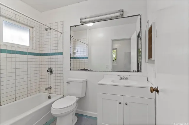 a bathroom with a sink toilet vanity and shower