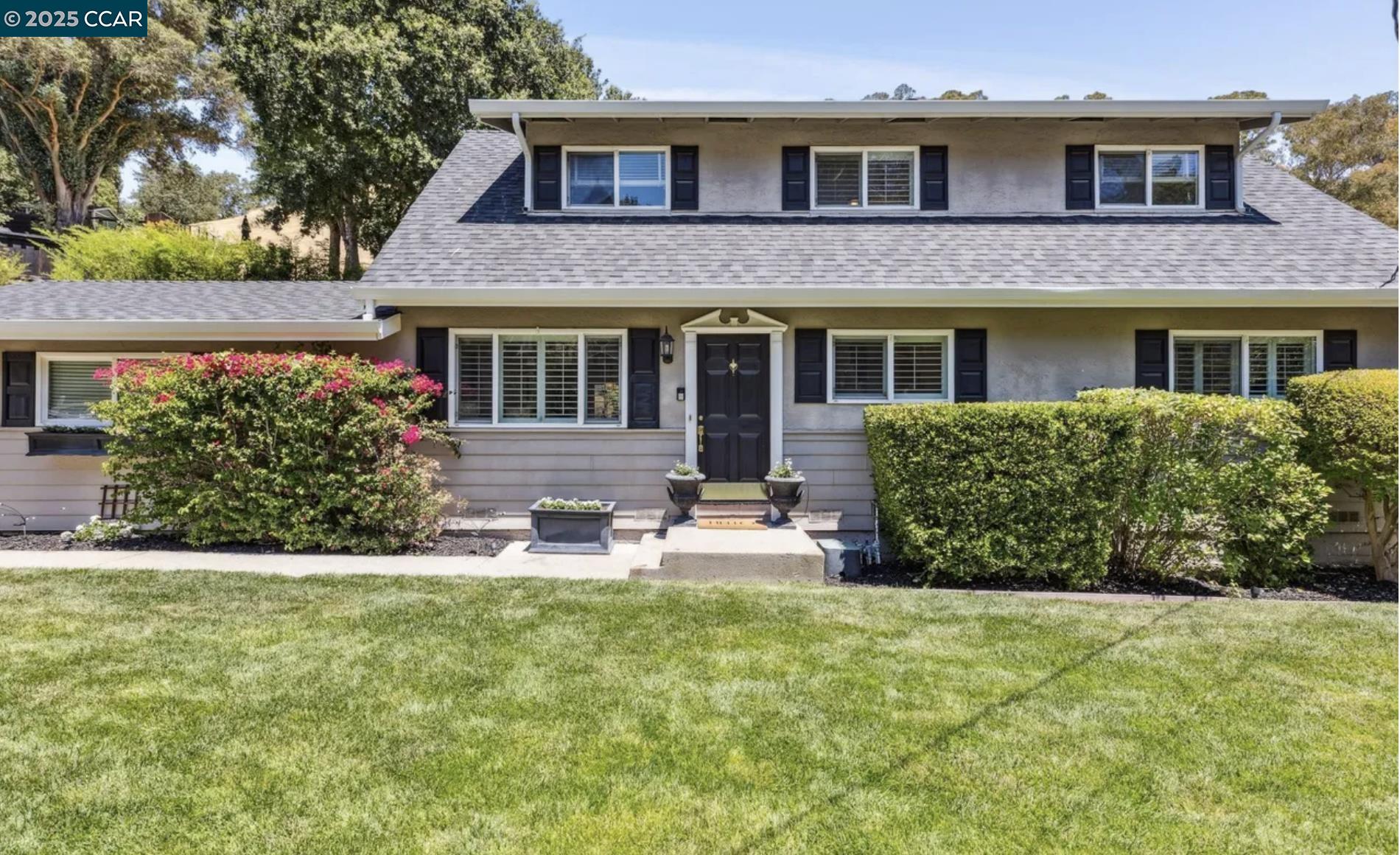 a view of a house with a yard and sitting area