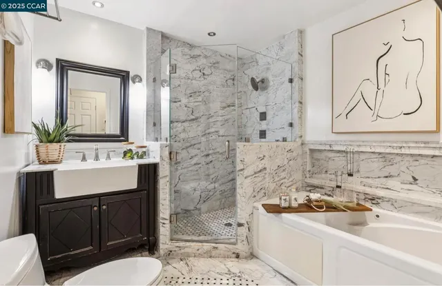 a bathroom with a sink a toilet and shower