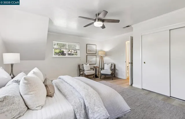 a spacious bedroom with a bed and a chandelier
