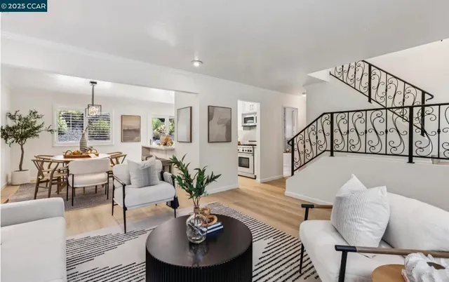 a living room with furniture potted plant and wooden floor