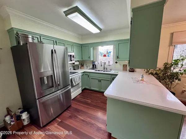 a kitchen with kitchen island a sink stove and refrigerator