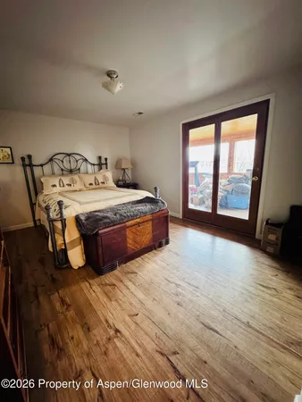 a spacious bedroom with a bed and a large window