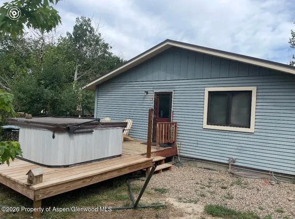 a view of house with backyard and sitting area
