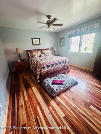 a bedroom with wooden floor