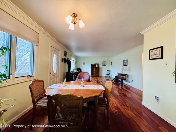 a view of a dining room with furniture and a chandelier
