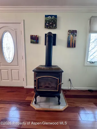 a living room with a clock on wall and a window